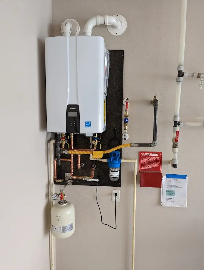 Professional plumber installing copper piping in a Westway home